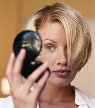 Woman Looking Into Compact Mirror